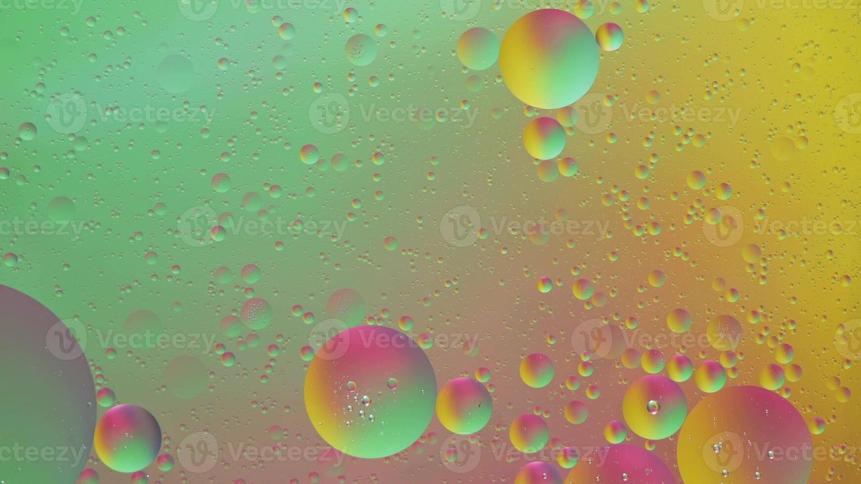 Abstract yellow, green and pink colorful background with oil on water surface. Oil drops in water abstract psychedelic, abstract image. photo