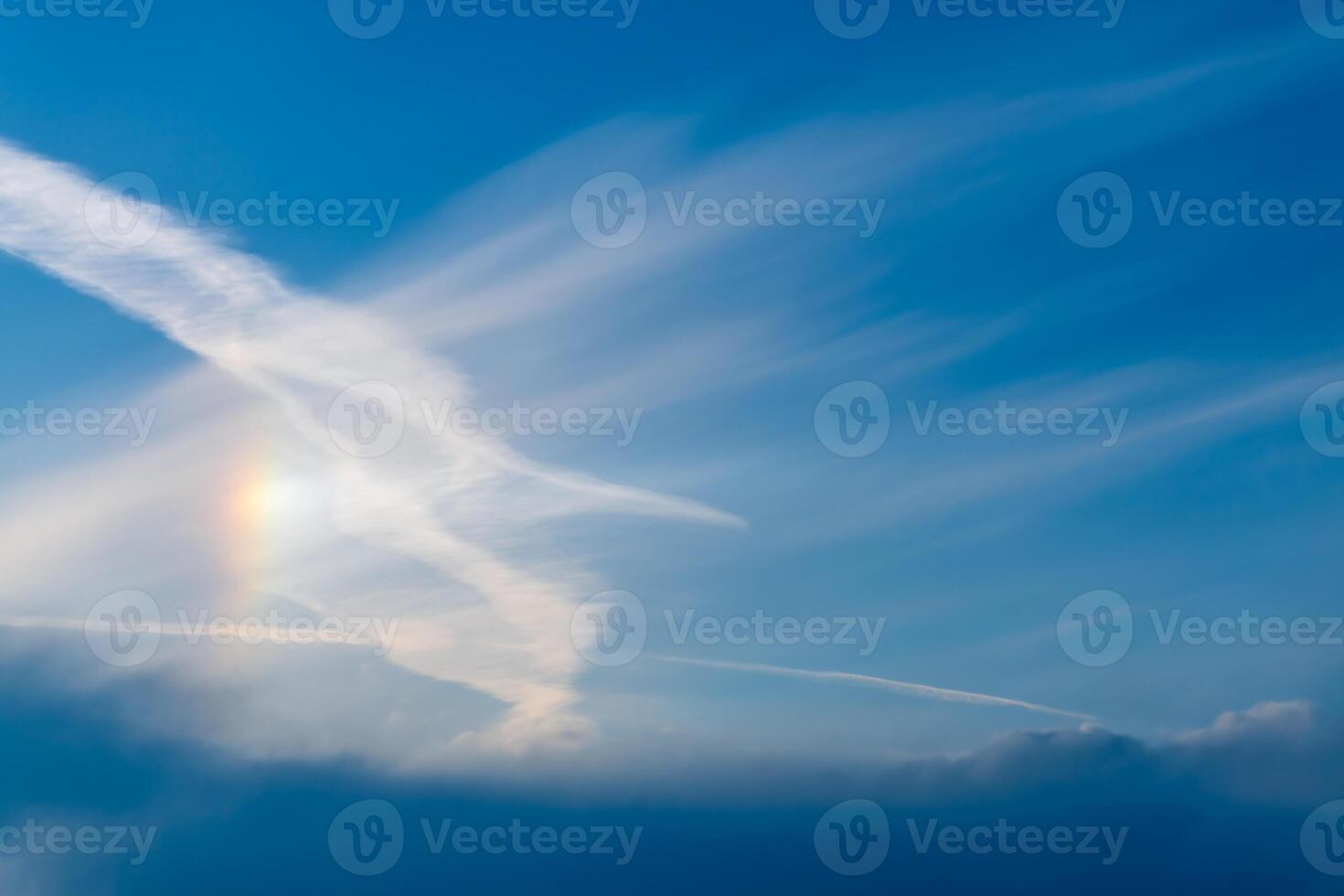 Sky with cirrus, stratus clouds and halo from the sun, rainbow photo