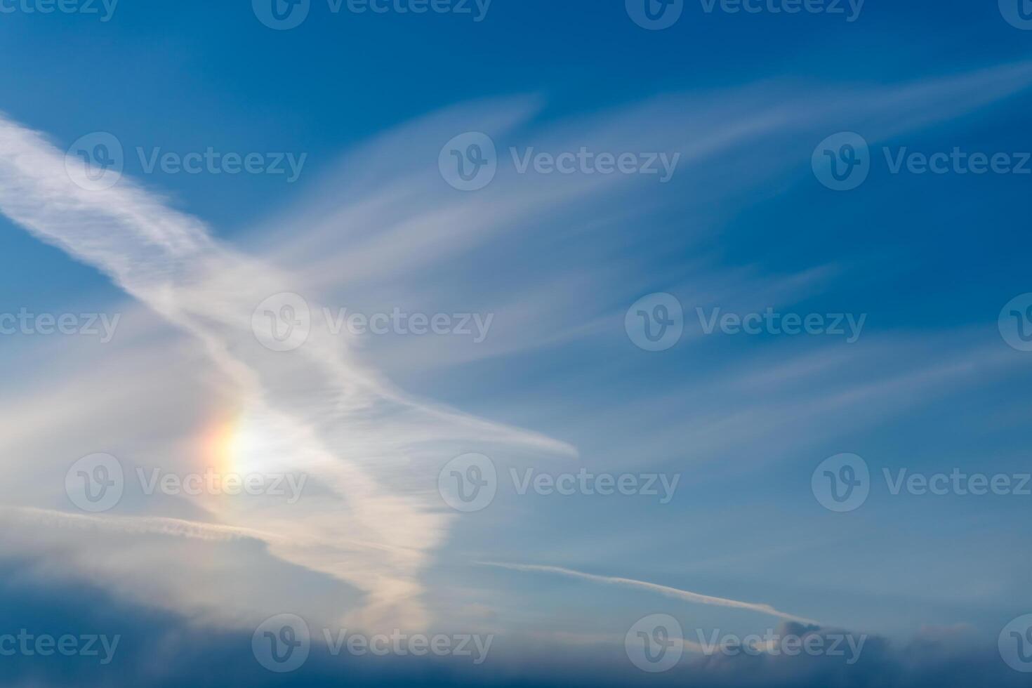 Sky with cirrus, stratus clouds and halo from the sun, rainbow photo