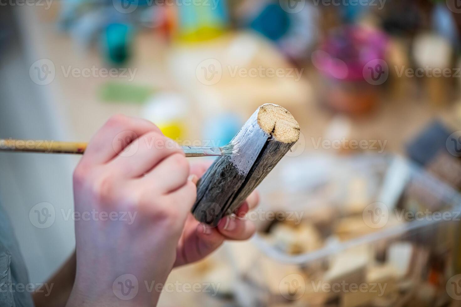 cute teen girl at a master class making a craft from wood, exhibition of crafts, crafts fair, education, master classes photo