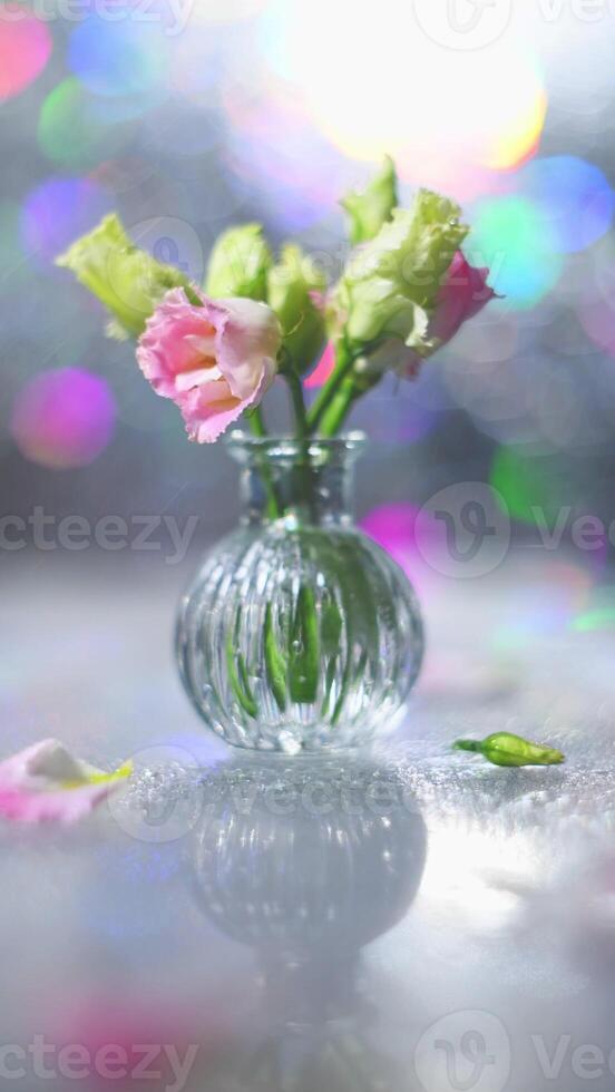 Beautiful pink and green flowers in a vase on a table photo