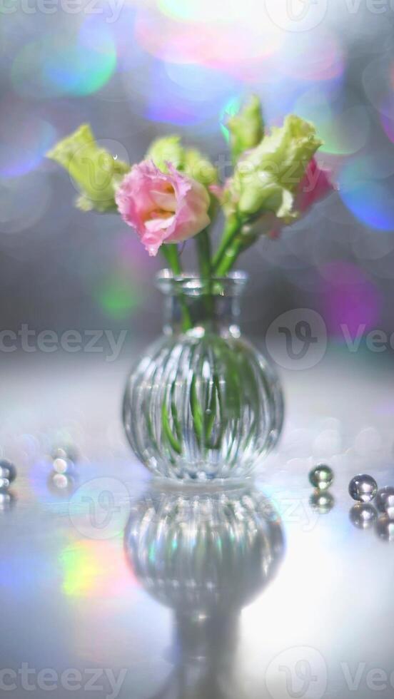 Beautiful pink and green flowers in a vase on a table photo