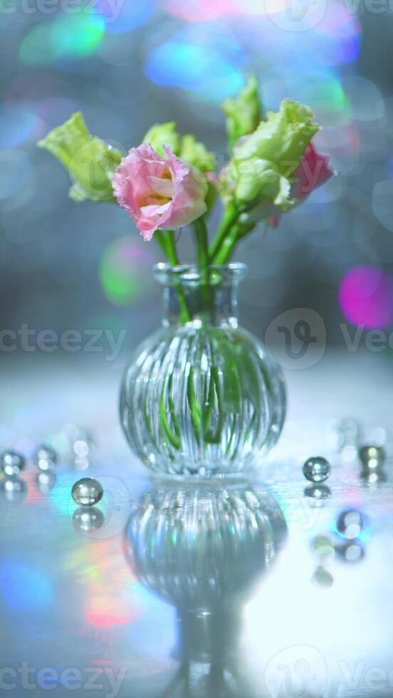 Beautiful pink and green flowers in a vase on a table photo