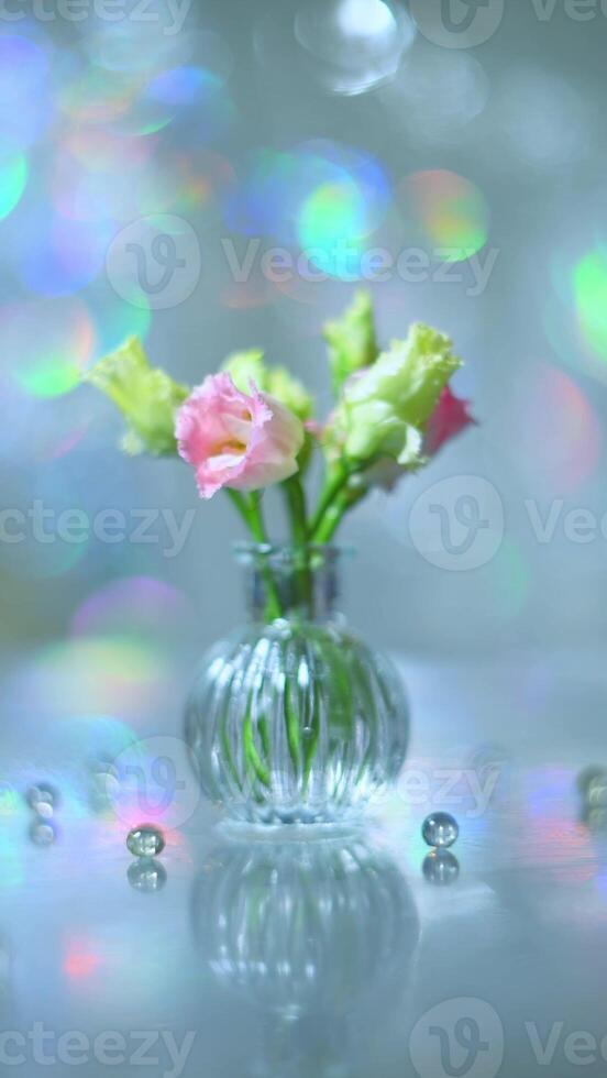 Beautiful pink and green flowers in a vase on a table photo