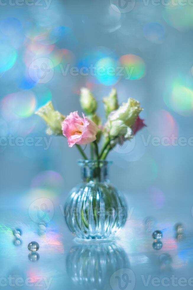 Beautiful pink and green flowers in a vase on a table photo
