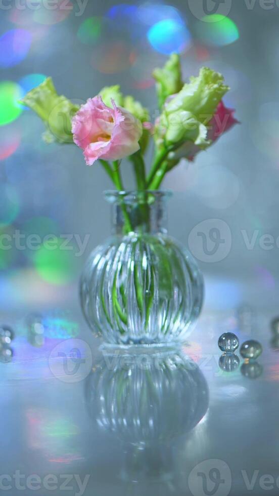 Beautiful pink and green flowers in a vase on a table photo