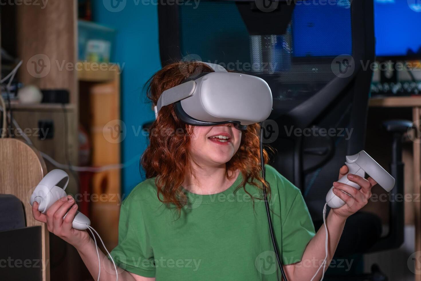 redhead teen girl at home in living room put on vr helmet to enjoy virtual reality online game cyber space world simulation. cute girl has fun using new electronic device for entertainment photo