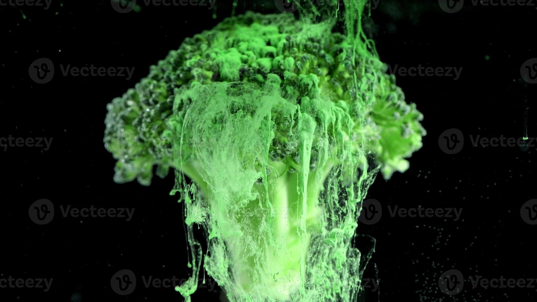 Fresh broccoli with a cloud of green color paint on black background. Artistic nutrition concept footage. 4K, Creative concept of vegetarianism, benefits of vegetables photo