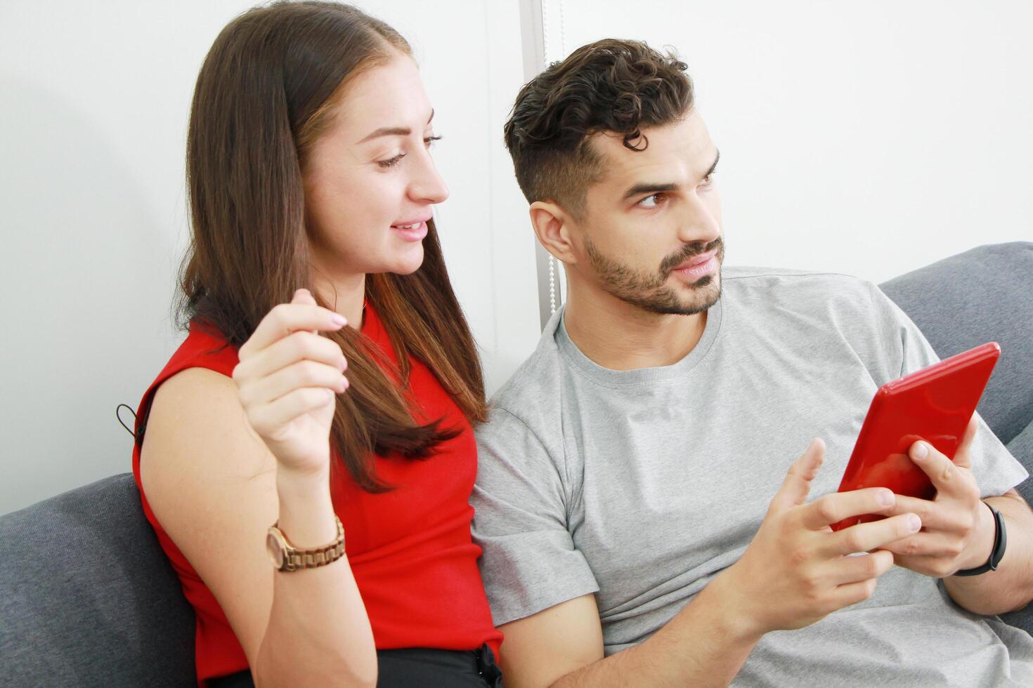 Smiling Caucasian Couple love relaxing and funny in online movie with tablet in social media technology on sofa in living room. Married family lifestyle on holiday Concept. photo
