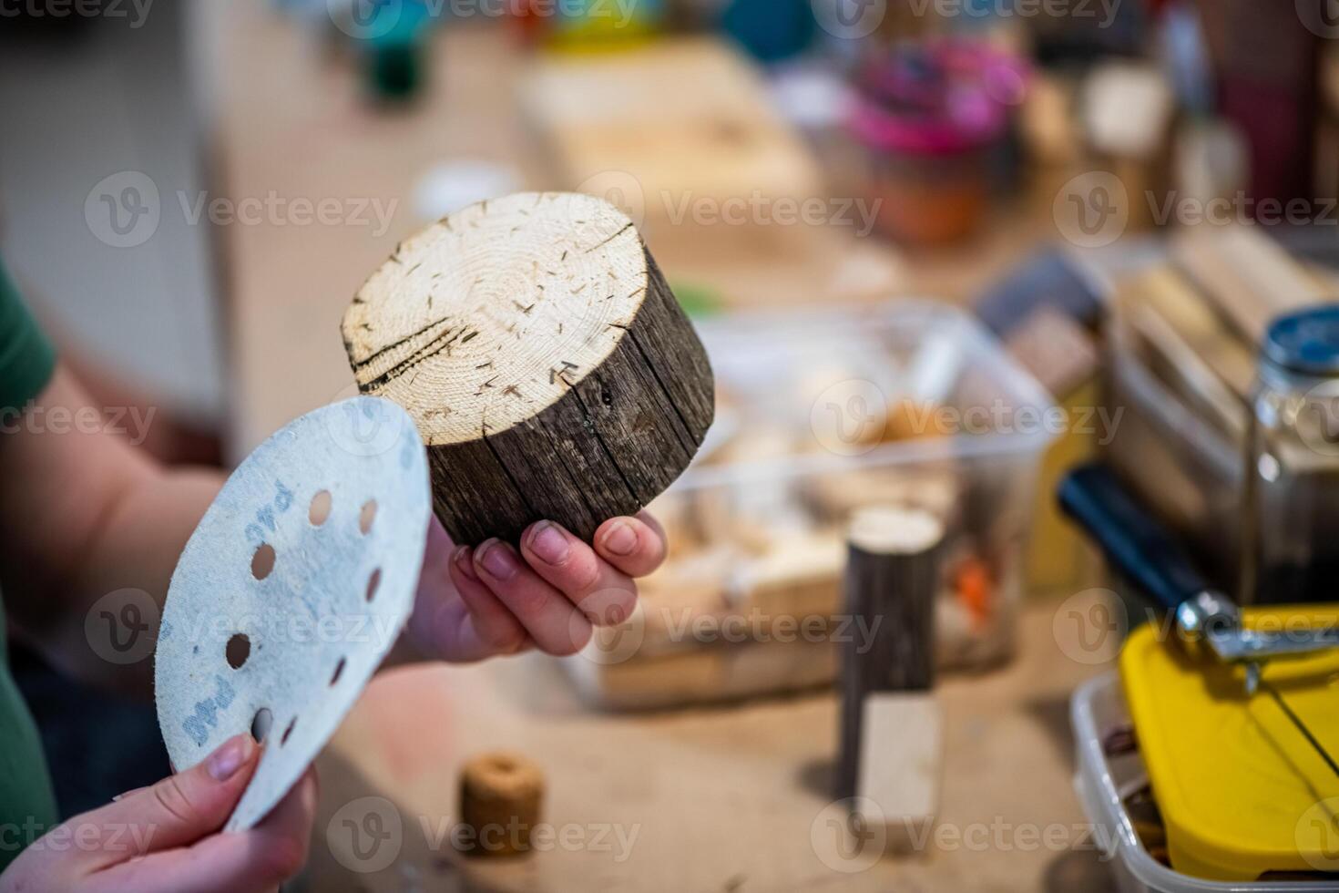 cute teen girl at a master class making a craft from wood, exhibition of crafts, crafts fair, education, master classes photo
