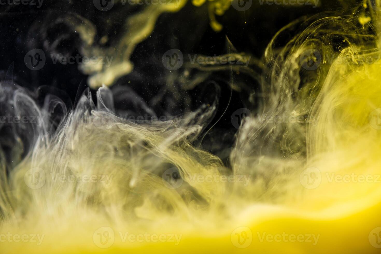 clouds of yellow smoke on a black background, clouds of paint in water, aquarium, abstract background, texture photo