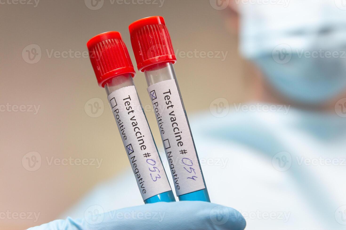 Coronavirus vaccine, positive and negative. Doctor in protective suit, medical mask and latex gloves holds a test tubes with vaccine. photo