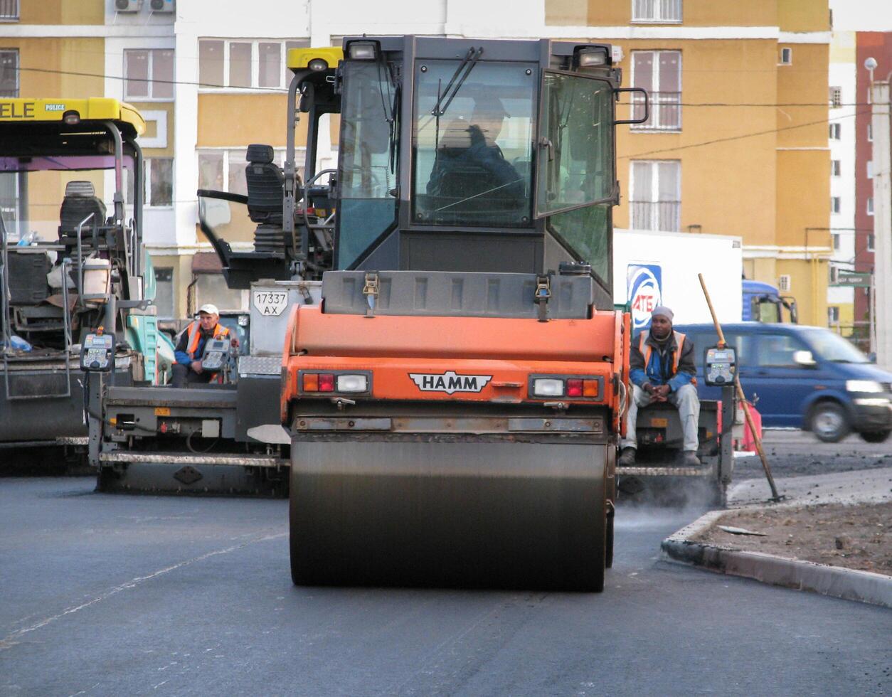Ukraine, Kharkiv, October 27, 2020. Close-up view on the workers and the asphalting machines photo