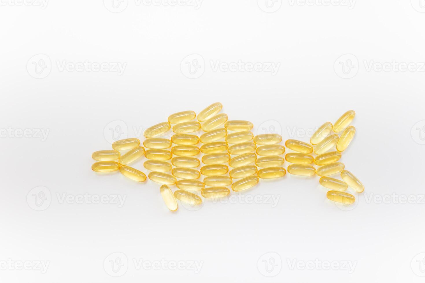 Fish shape Cod Liver Oil Capsules, Omega 3, Vitamin D on white background. Close-up, top view, copy space for your text. photo