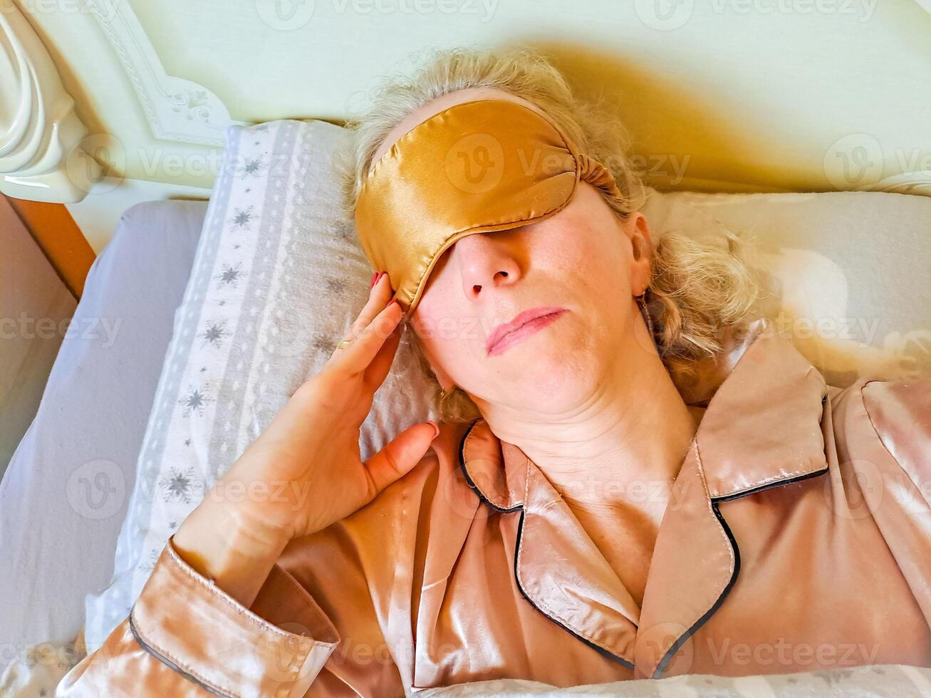 woman sleep and sweet dream lying on bed in cozy bedroom in the morning photo