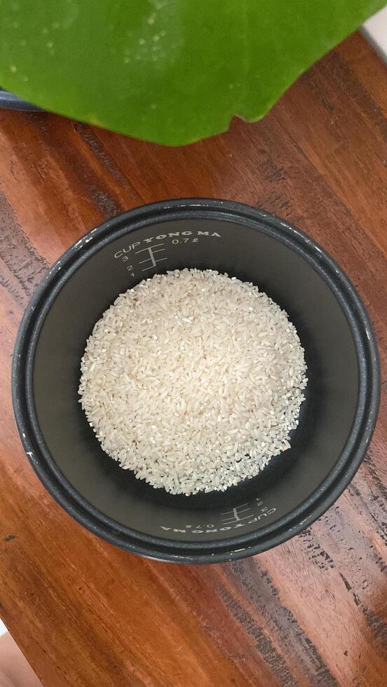 there is a bowl of rice sitting on a table next to a banana photo