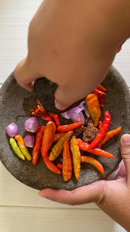 there is a bowl of peppers and other vegetables on a table photo