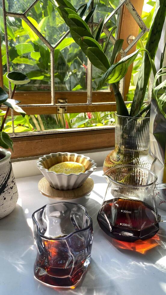 there is a glass bowl with lemon slices on top of coffee grounds, with a coffee filter photo