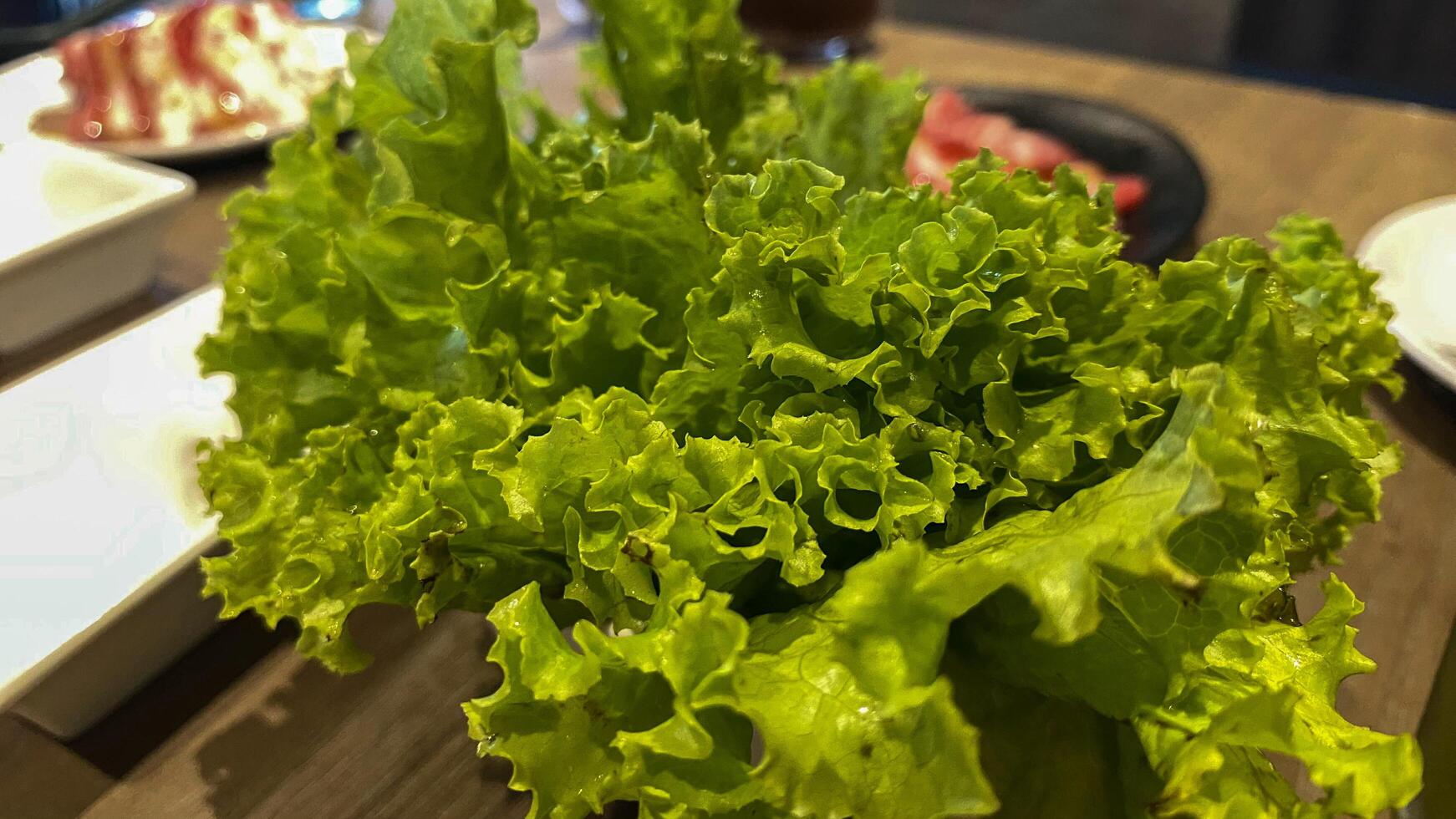 there is a salad and a drink on the table photo