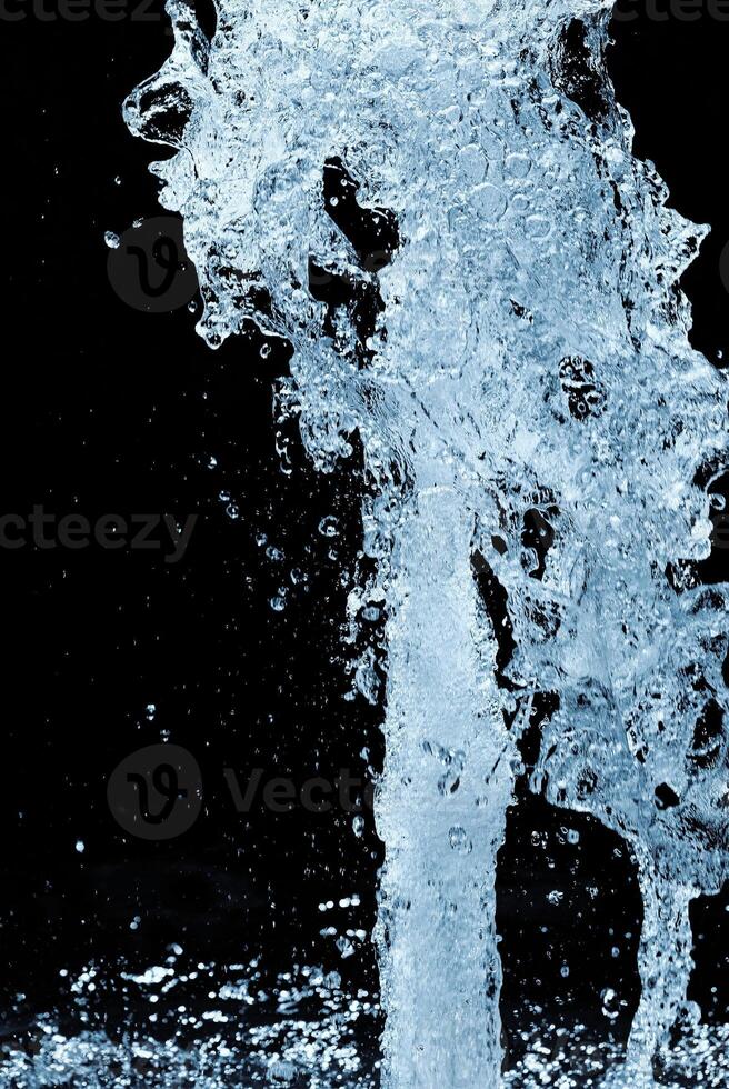 Fragment of waterfall on black background photo