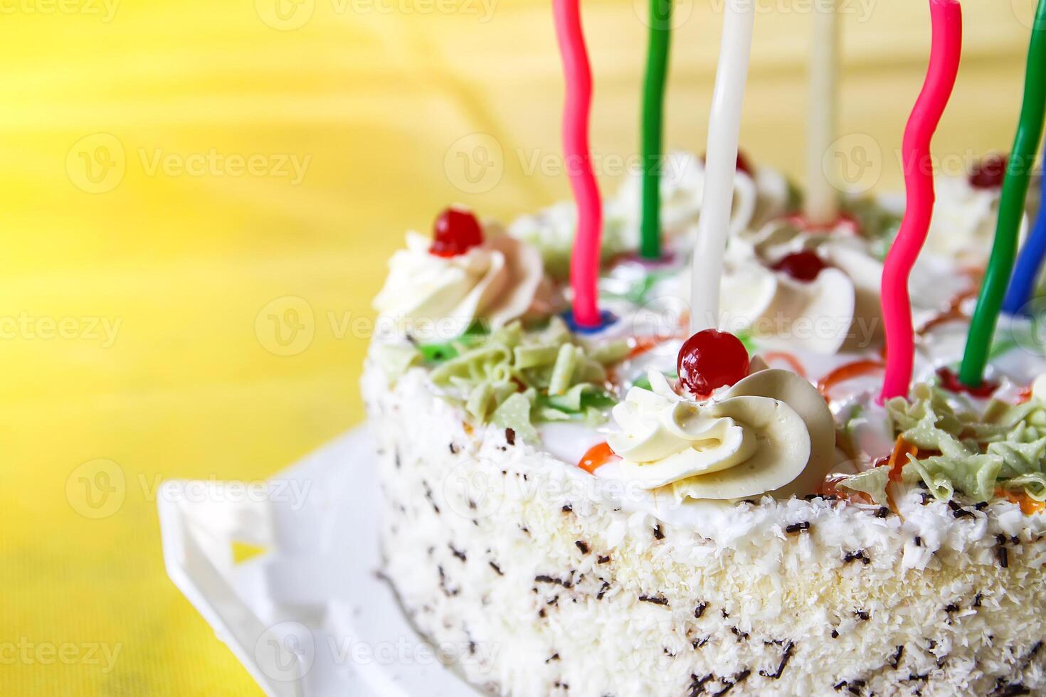 Traditional sweet birthday cake with colorful candles. photo