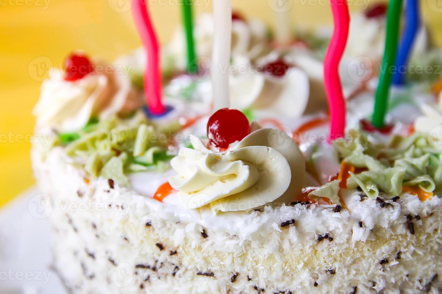 Traditional sweet birthday cake with colorful candles. photo