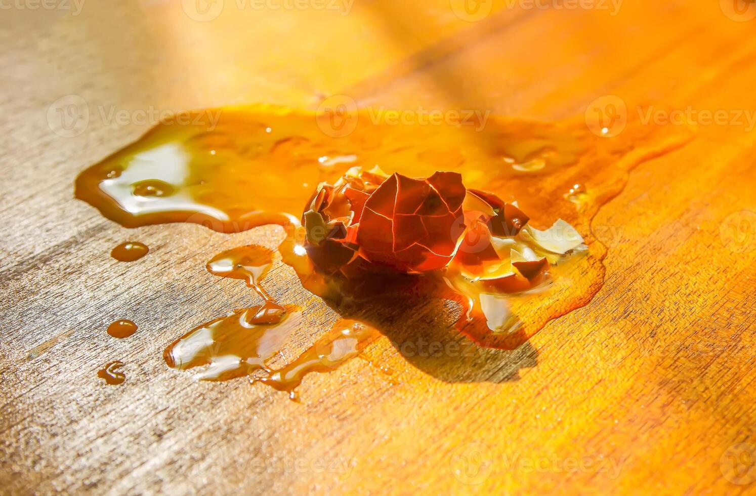 Raw smashed egg on wooden table. photo