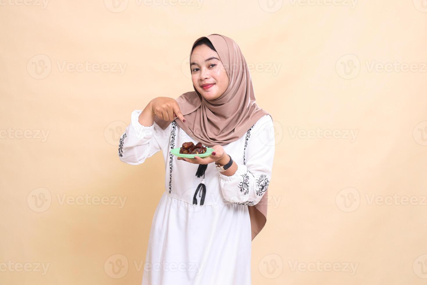 a beautiful indonesia Muslim woman wearing a hijab was surprised to bring dates for sahur and breaking the fast. used for advertising, health, Eid and Ramadan photo