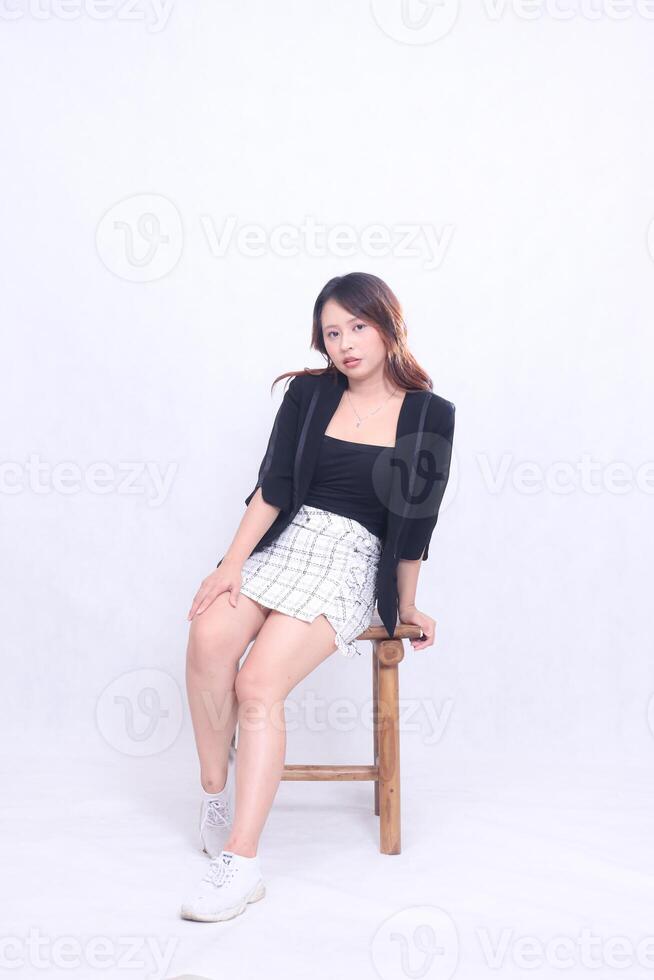 full body beautiful asian woman 20s formal office elegant sexy hands resting on chair sitting on wooden chair isolated white background photo