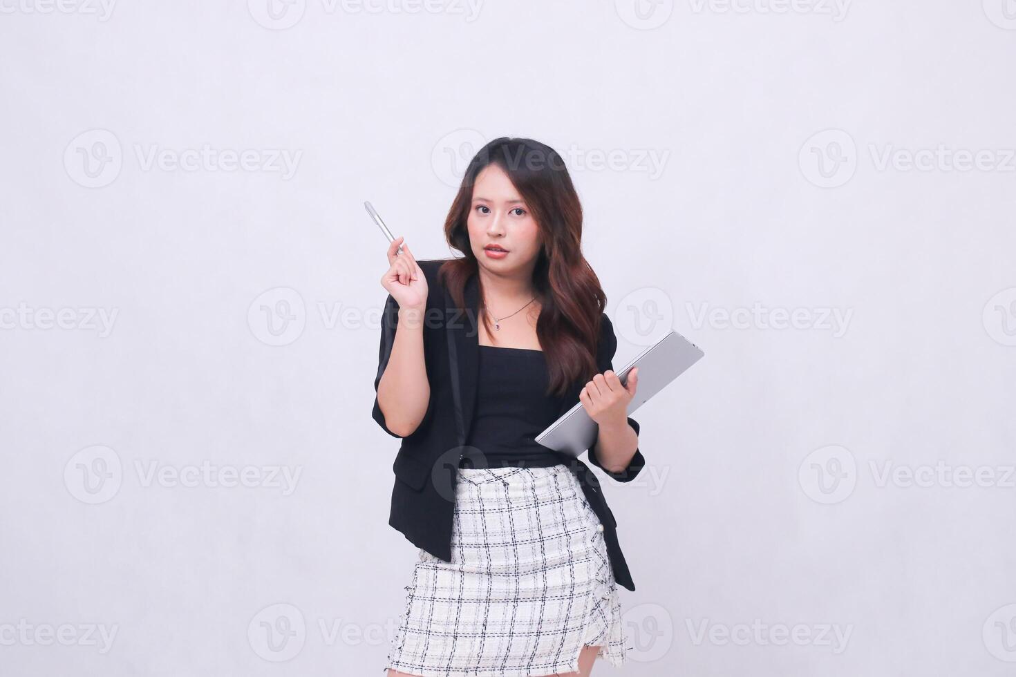 young beautiful girl customer 20s formal office sexy smile looking at camera holding pen sideways right and hugging tablet isolated white background photo
