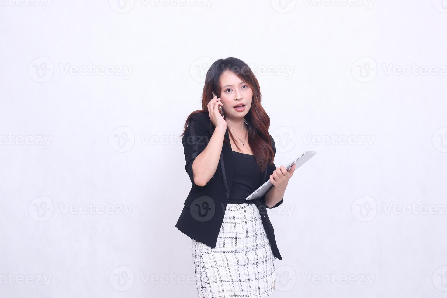 beautiful southeast asian woman 20s formal office smiling surprised on the phone carrying tablet for promo isolated white background photo