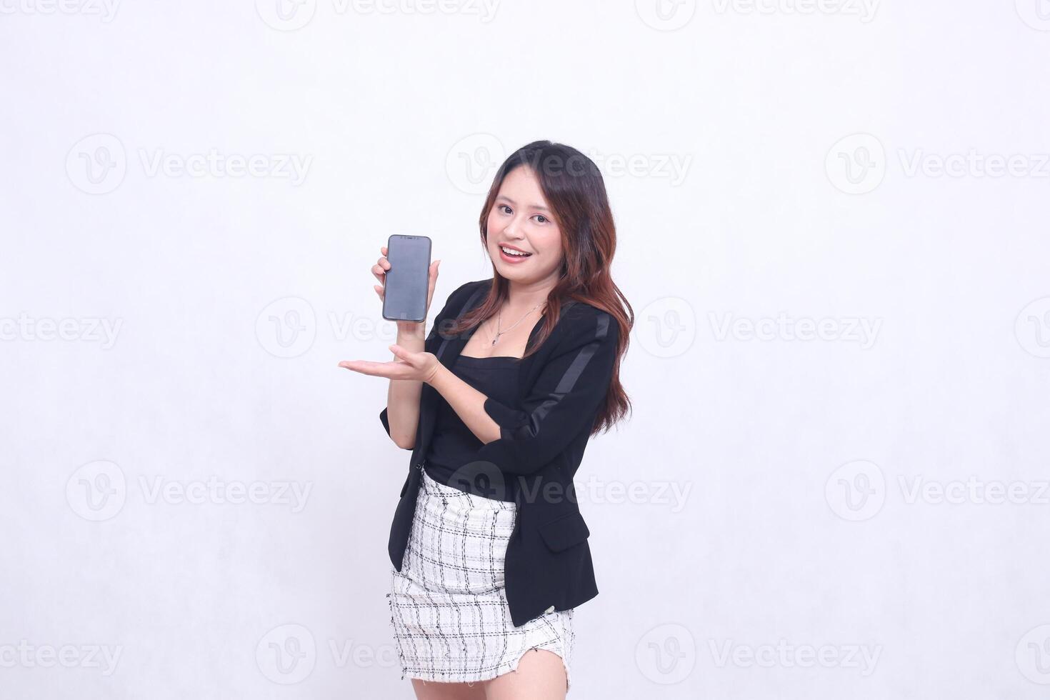 beautiful Indonesian office woman 20s cheerful smile expression promotion cellphone gadget screen hands welcome to promo isolated white background photo