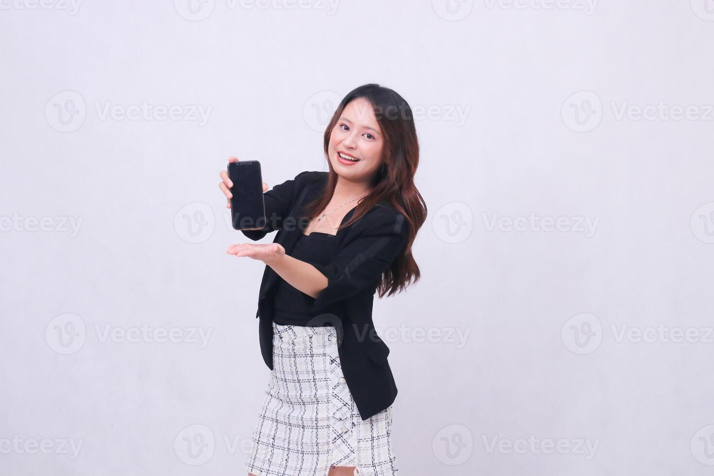 beautiful Indonesian office woman 20s smiling expression promoting cell phone gadget screen in front for promo with hands underneath isolated on white background photo
