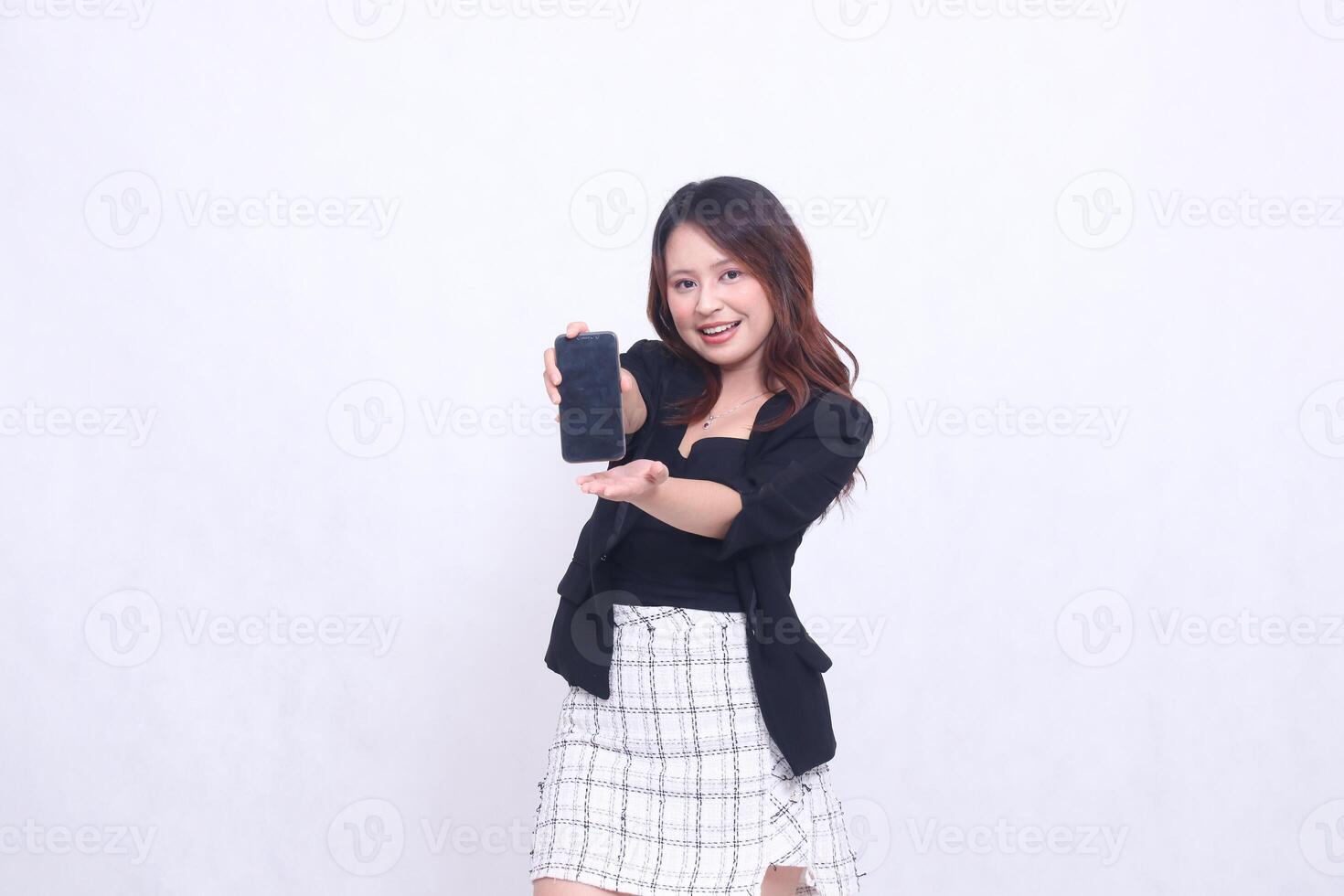 beautiful Indonesian office woman 20s cheerful smile expression promotion cellphone gadget screen hand welcome forward for promo isolated white background photo