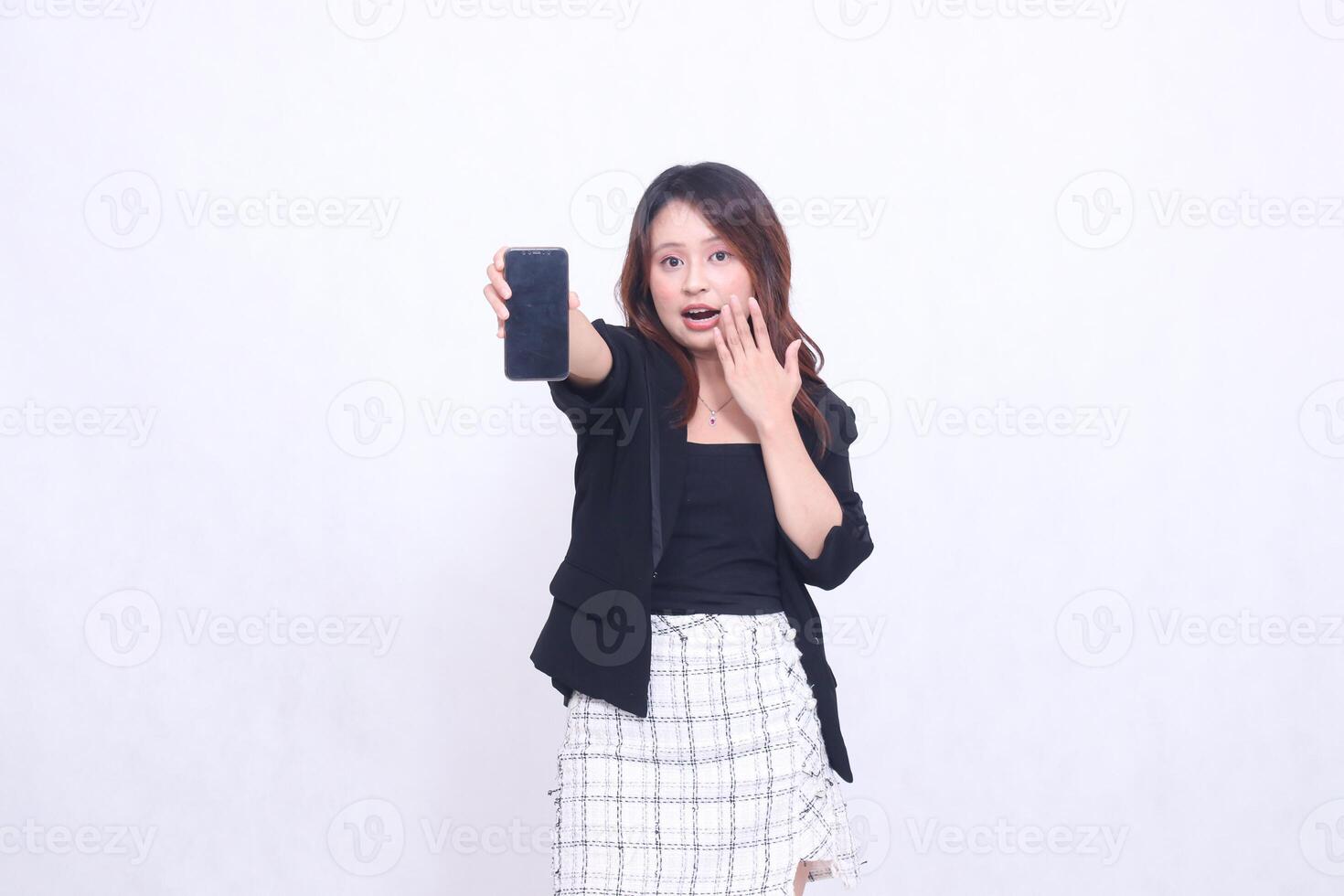 Beautiful Indonesian office woman in her 20s, expression of surprise, promotion on cellphone gadget screen in the future for promo, isolated on white background photo