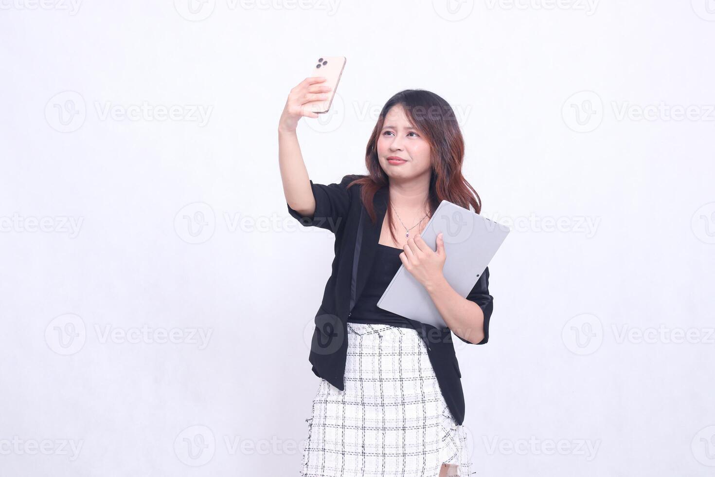 beautiful southeast asian woman 20s formal office crying looking at cellphone while calling her parents and carrying tablet for promo isolated white background photo