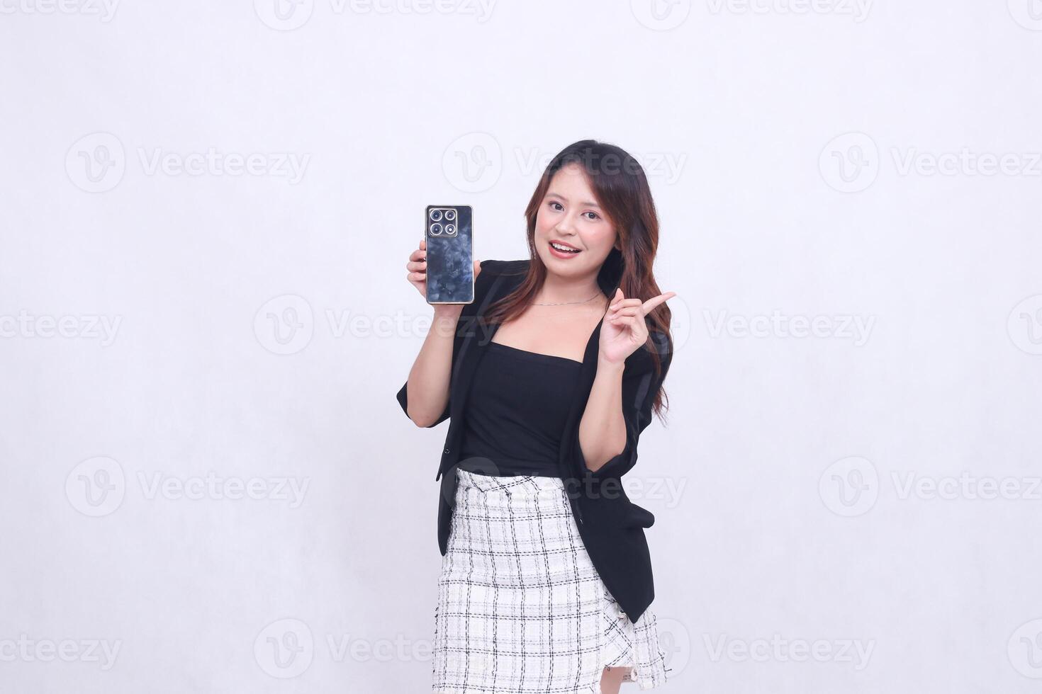 charm of beautiful Asian office girl 20s cheerful expression carrying cell phone gadget facing back while hand pointing left isolated white background photo
