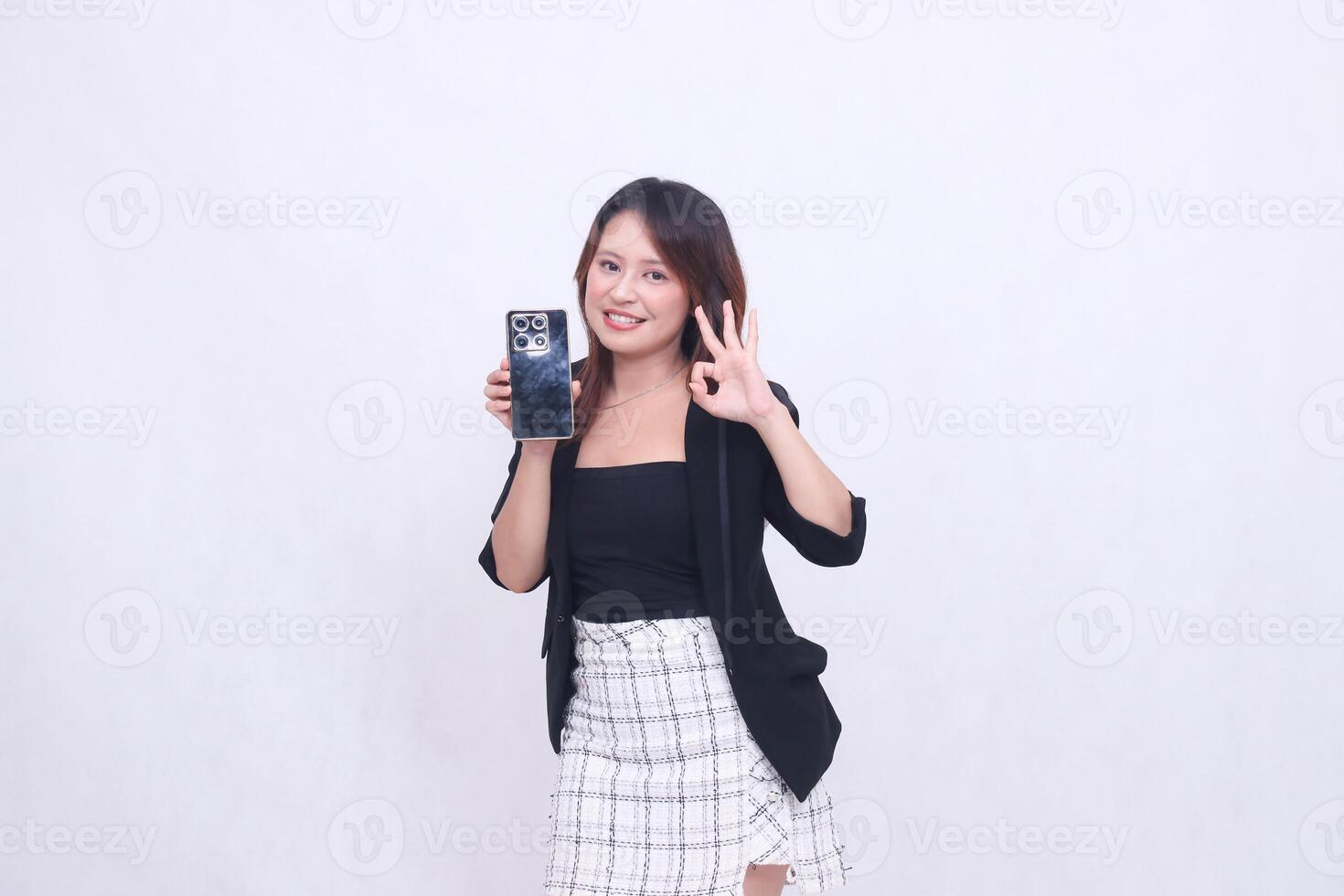 charm beautiful asian office girl 20s cheerful expression carrying cellphone gadget facing back while hand nice circular sign isolated white background photo