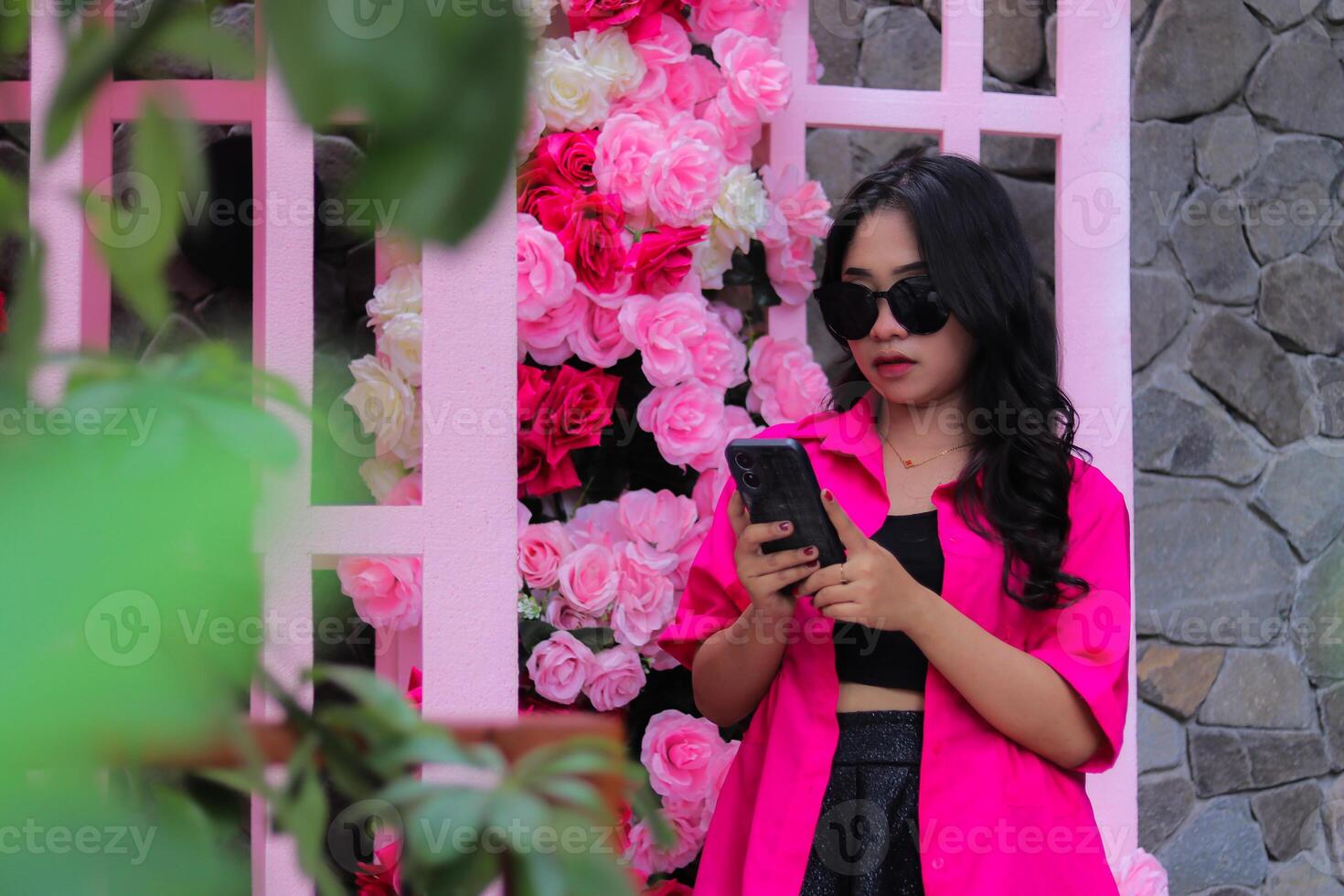 beauty asian woman in pink shirt glasses candid elegant carrying cellphone for business flower decoration for fashion, lifestyle, banner, promo content photo