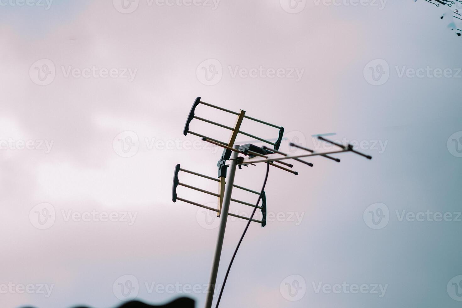 A TV antenna standing tall against the sky, ready to capture broadcast signals photo
