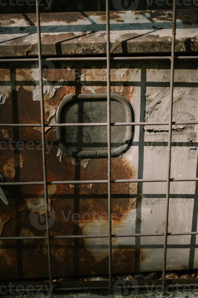 A network server in a public space, securely enclosed in a metal cage, highlighting technology and security measures photo