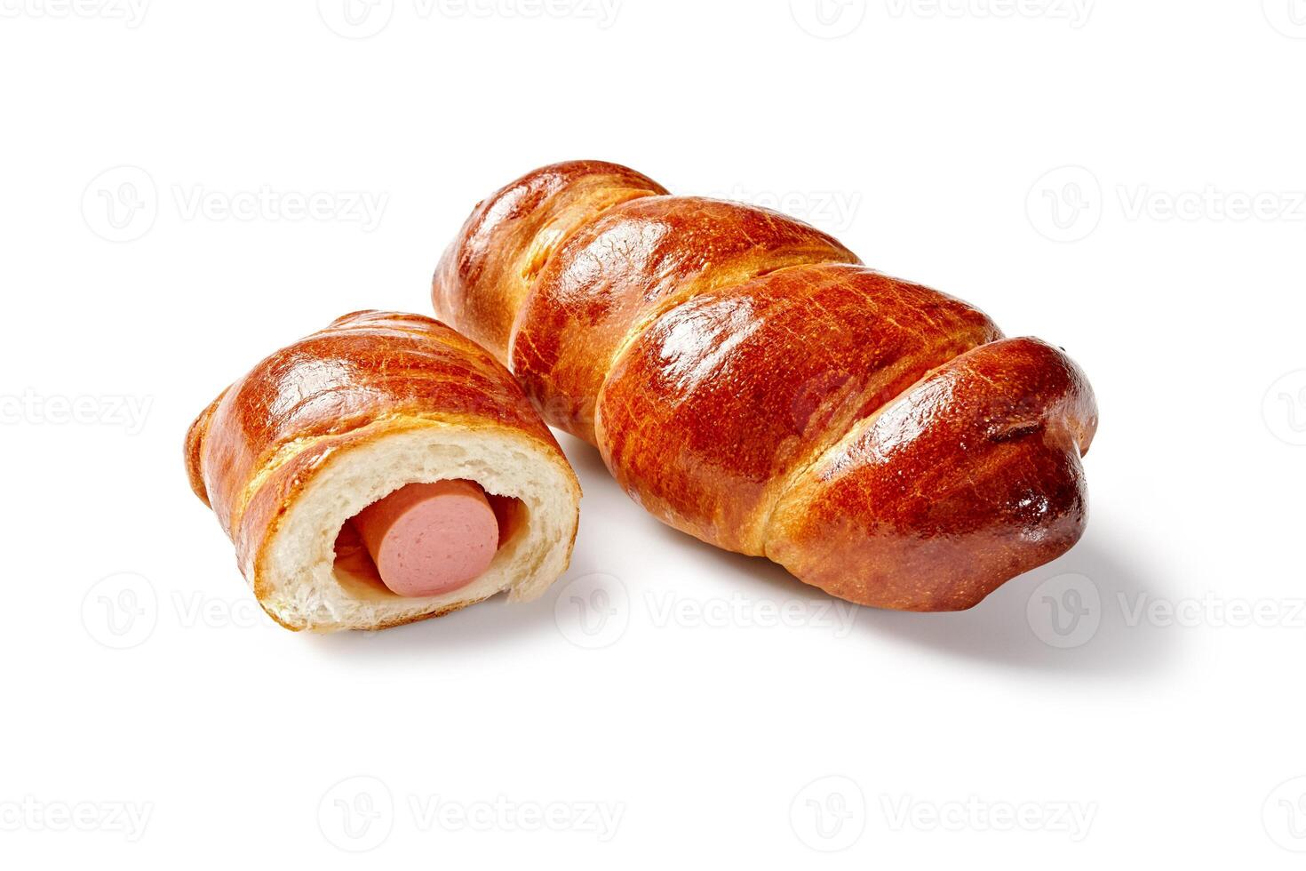 Freshly baked browned sausage rolls on white background photo