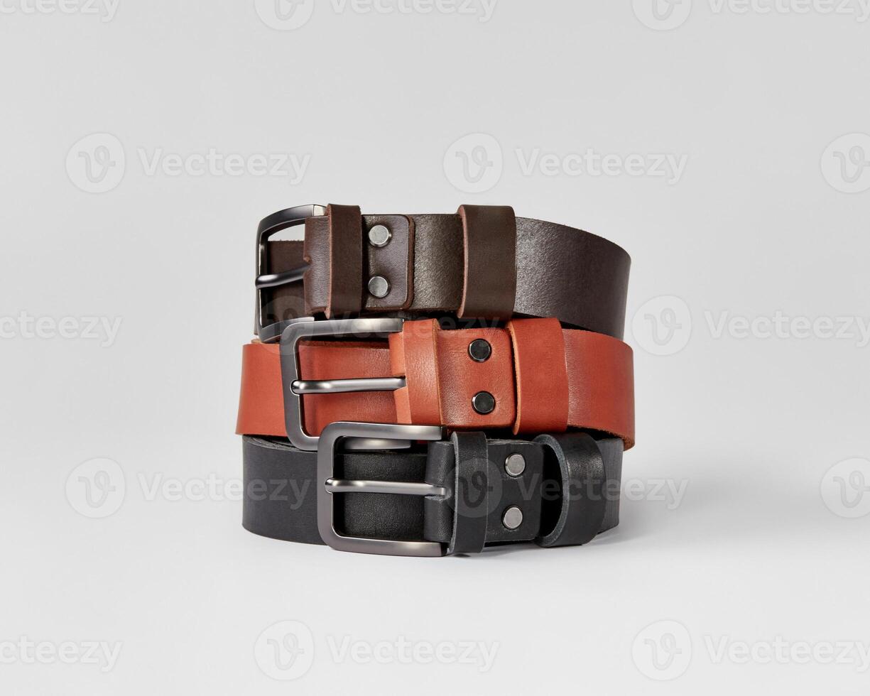 Three folded leather belts of different colors with DAD embossing photo