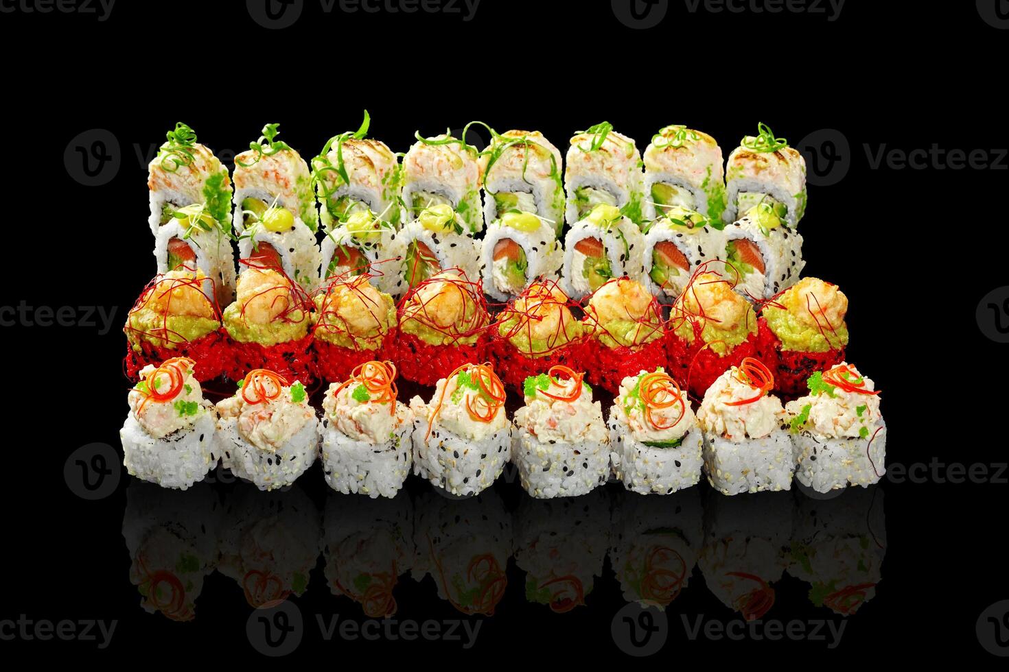 Enticing set of sushi rolls with various fillings and toppings on black photo