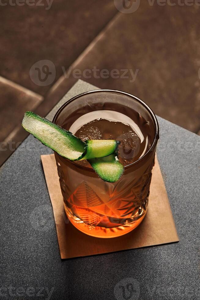 Refreshingly herbal and floral gin garden with cucumber slice photo