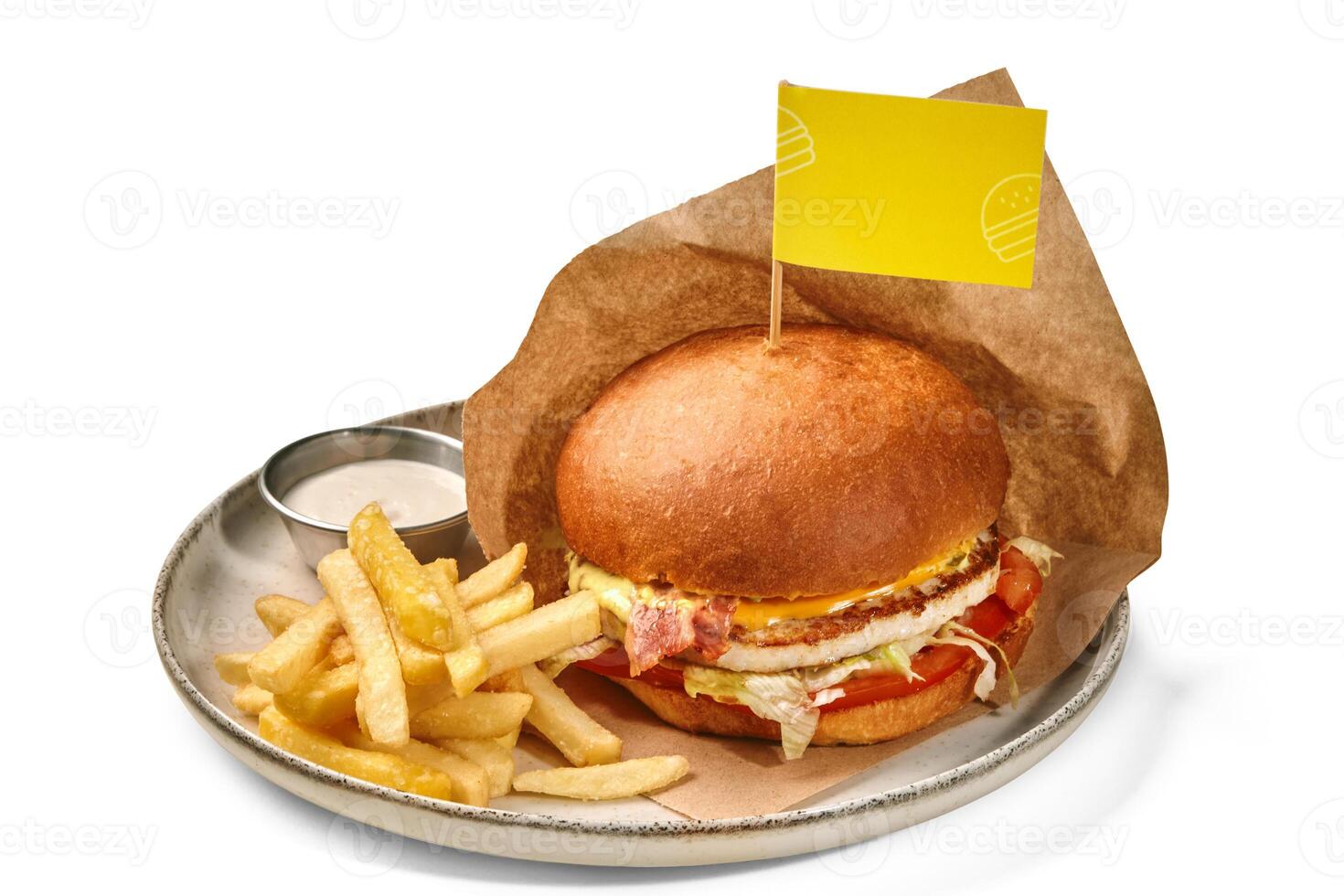 Appetizing chicken burger with fries and sauce on plate photo