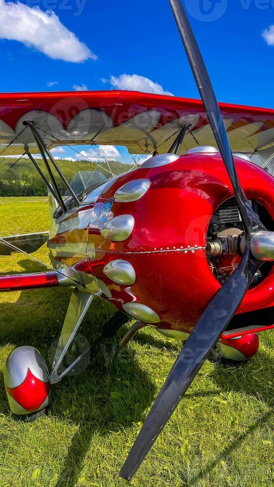 Old red airplane turboprop engine with propeller blades, parts of wings and aircraft fuselage photo