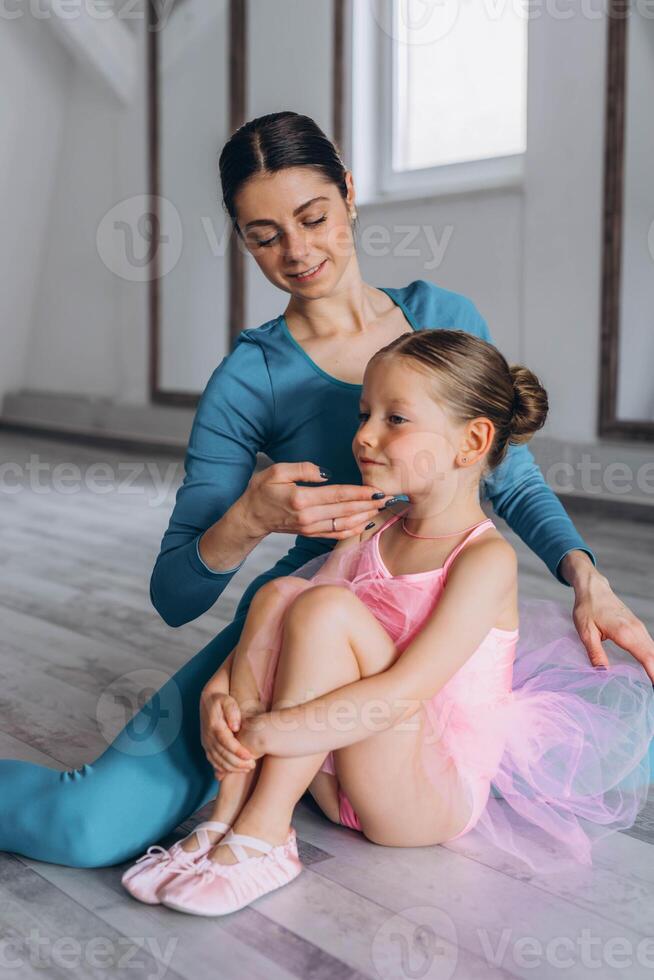 Baby ballet studio. Little ballerina with a coach in dance class. Ballet trainer for children photo