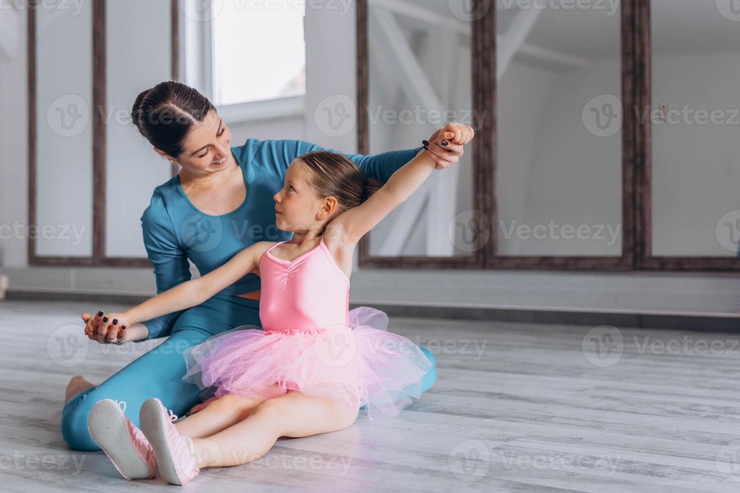 Baby ballet studio. Little ballerina with a coach in dance class. Ballet trainer for children photo