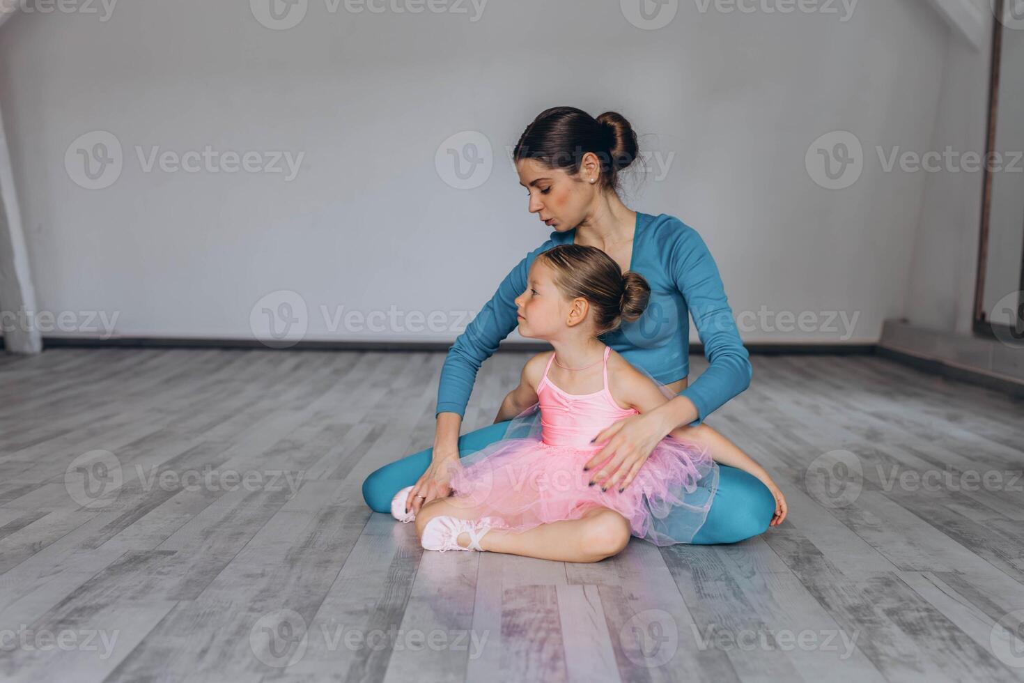 Baby ballet studio. Little ballerina with a coach in dance class. Ballet trainer for children photo